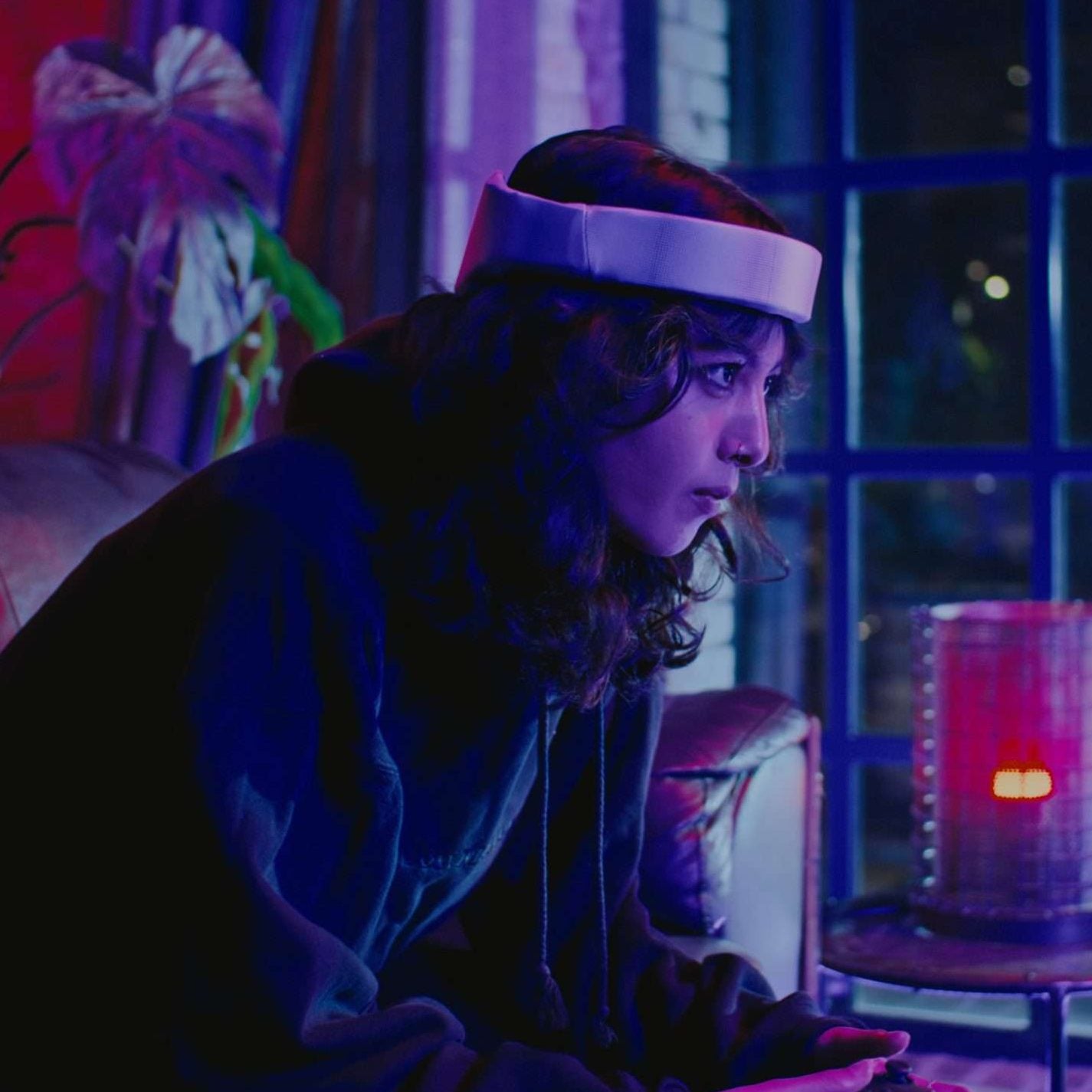 Rezon Halos® brain protection in everyday use. Image shows a woman playing on a games console while wearing Rezon Halos®.