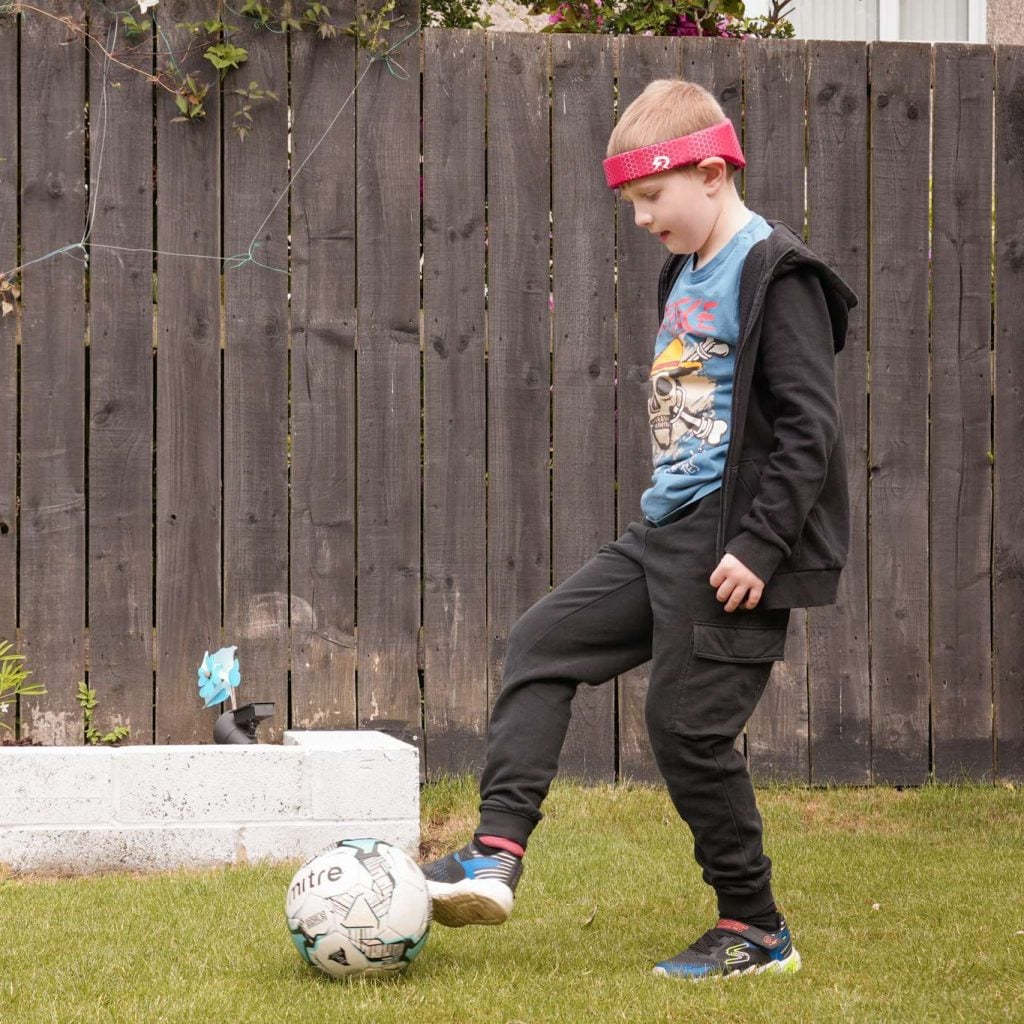 Young boy playing football in Rezon Halos® Image shows a young boy playing football in Rezon Halos®.