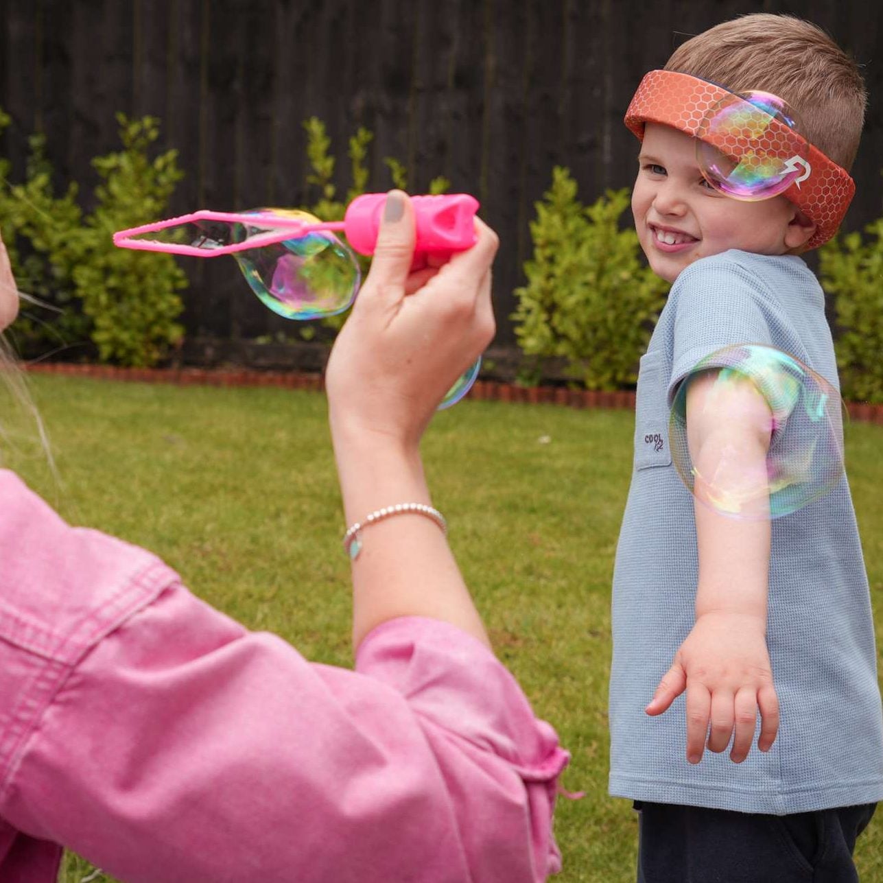 Young child wearing Rezon Halos® brain protection Image shows a young child wearing Rezon Halos® brain protection while playing in the garden.