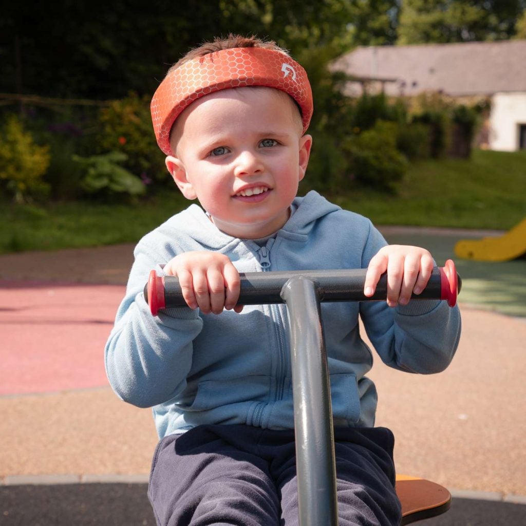 Rezon Halos® brain protection worn by a boy at the park.