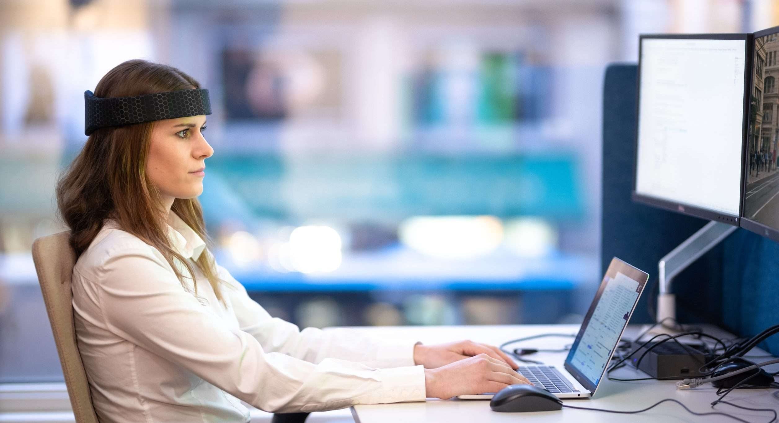 A woman wearing Rezon Halos® brain protection while at work.