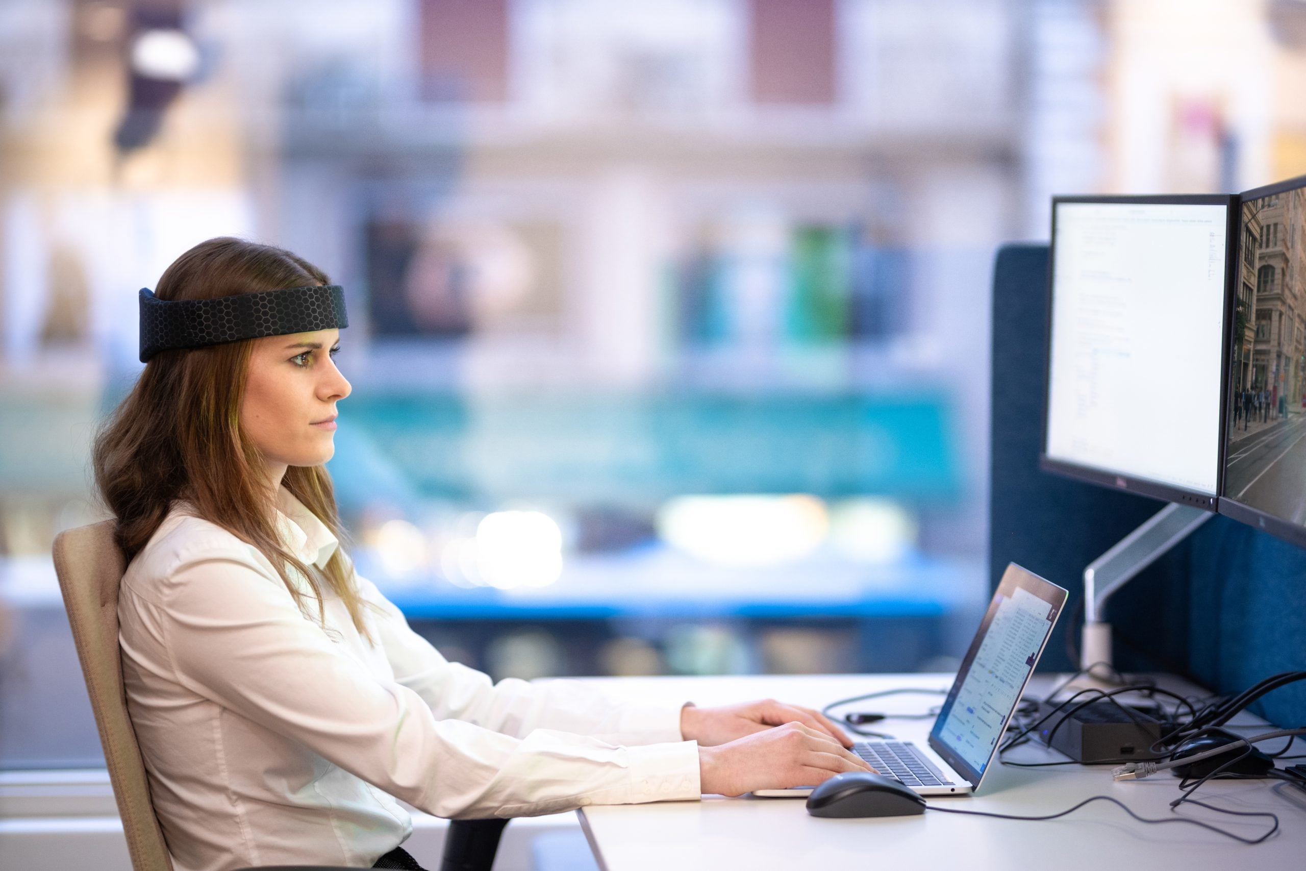 A woman wearing Rezon Halos® brain protection while at work.